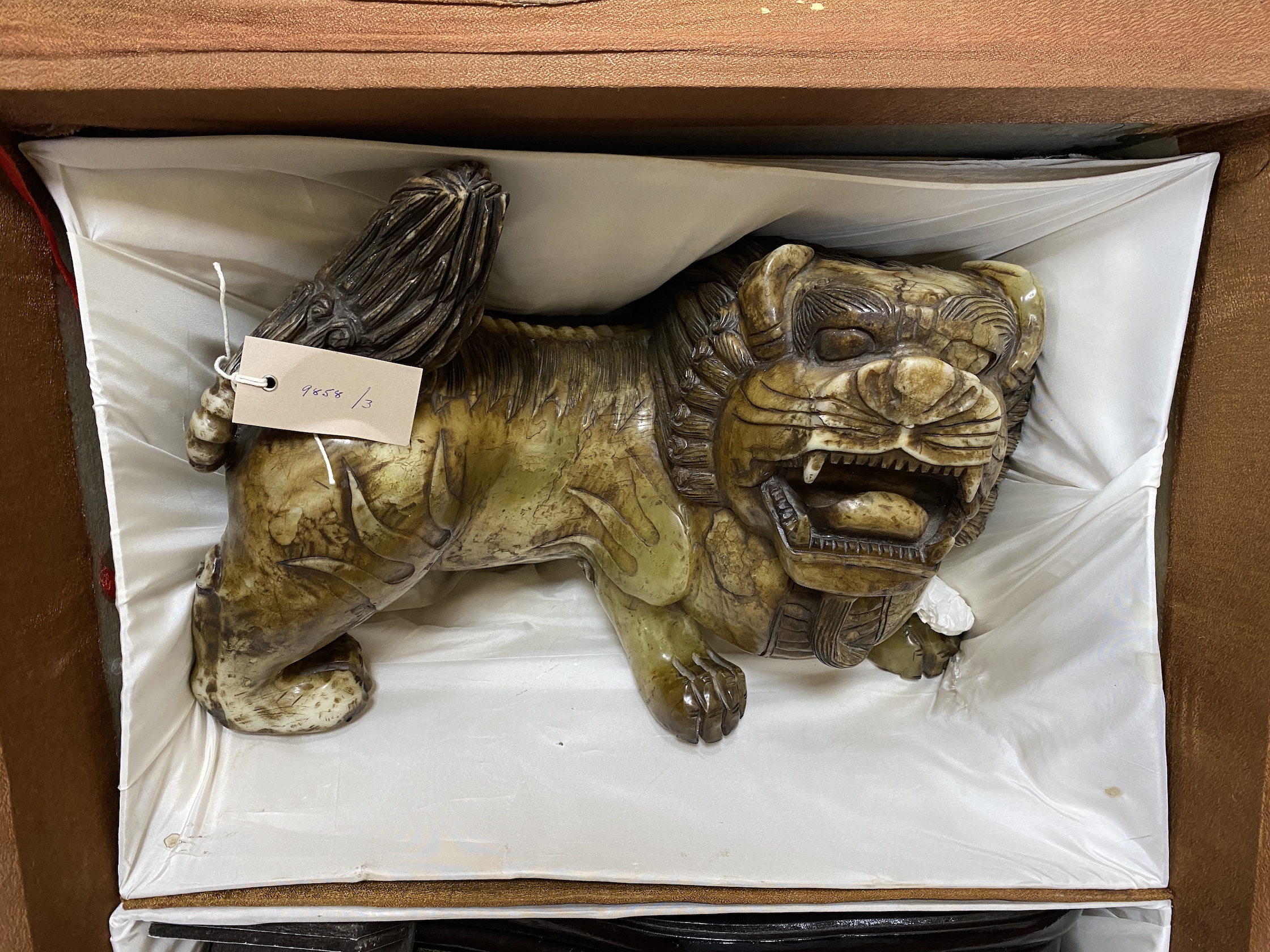 A massive Chinese soapstone figure of a lion-dog, 43cm wide (excl. stand), boxed